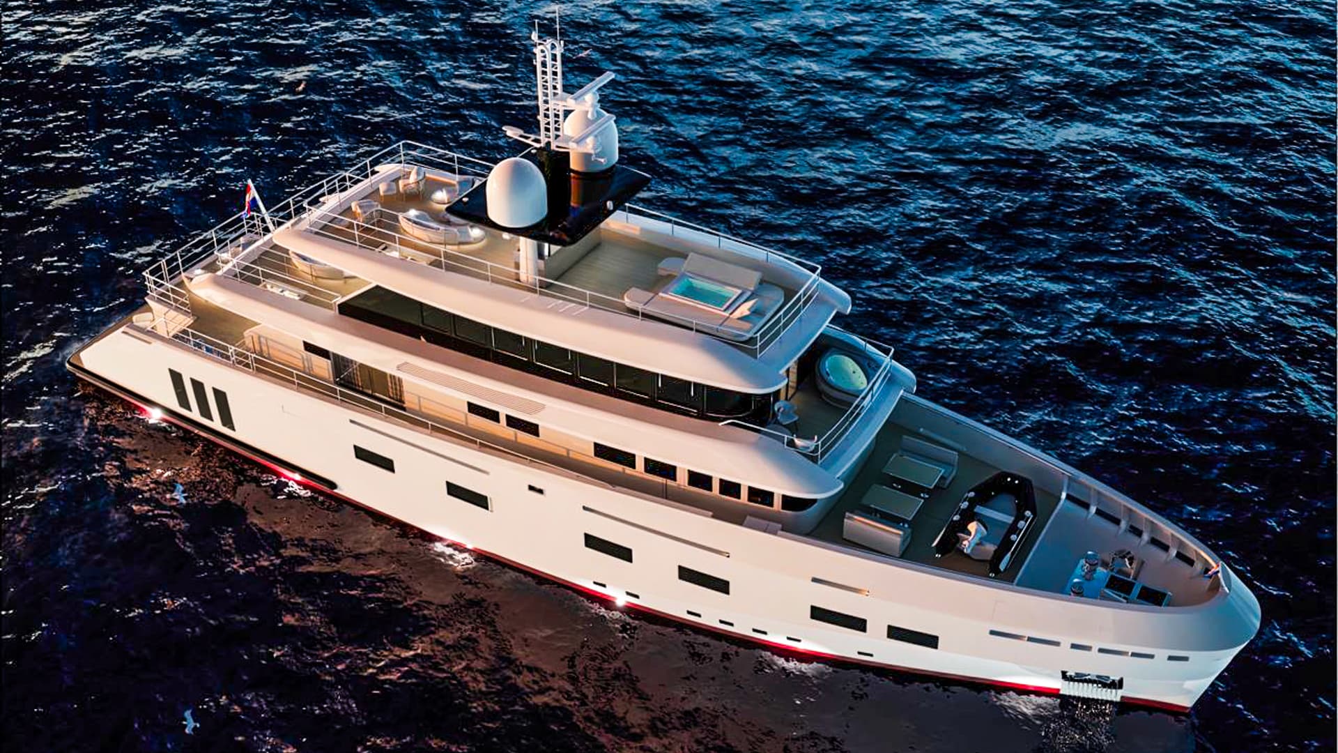 Large white motor yacht with jacuzzis cruising on dark blue, wavy ocean water.