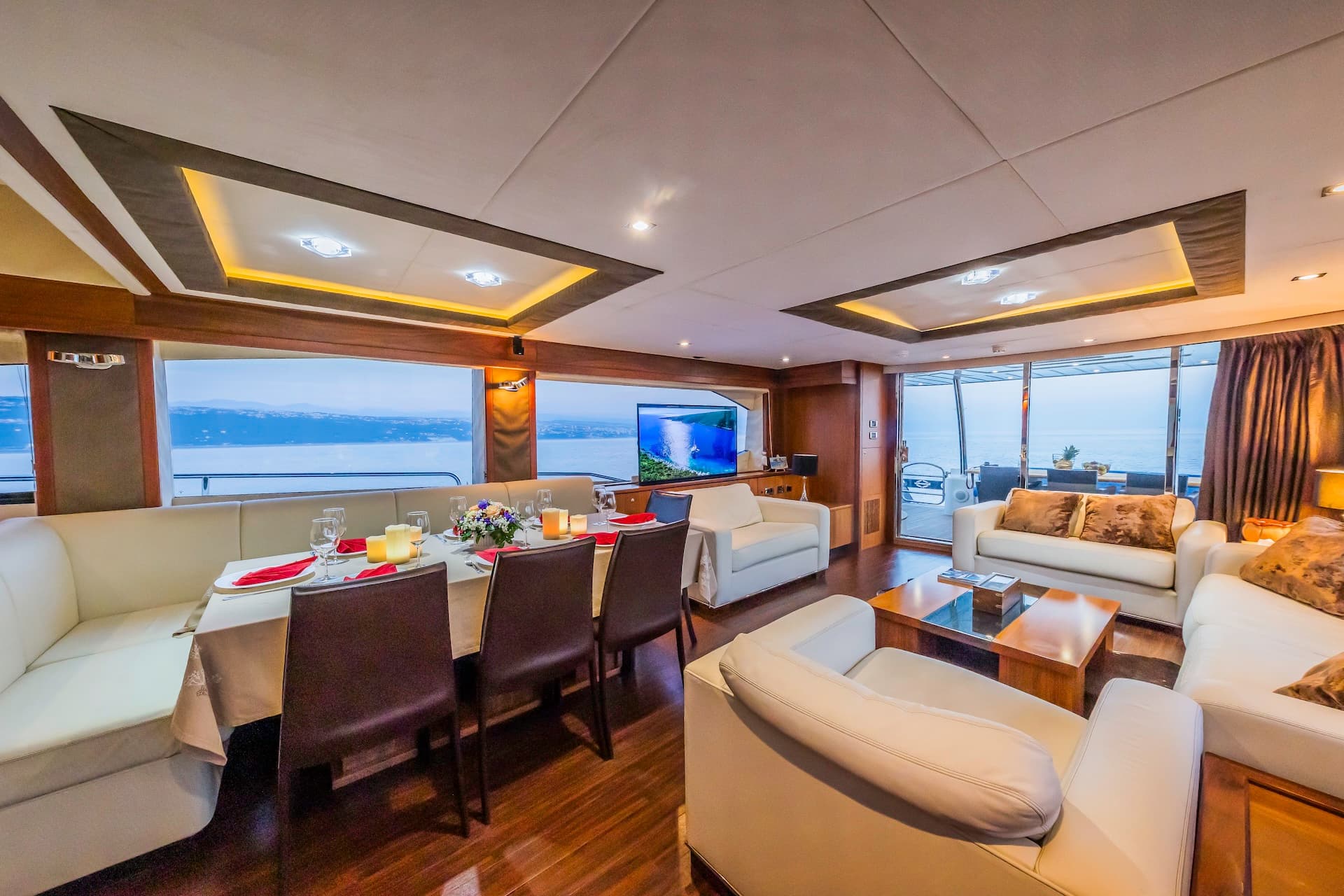 Yacht interior with dining area and lounge, showing sea view in Croatia