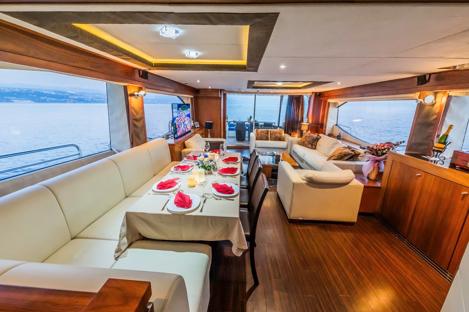Yacht interior with formal dining setup and sea view, Croatia suggested by filename.