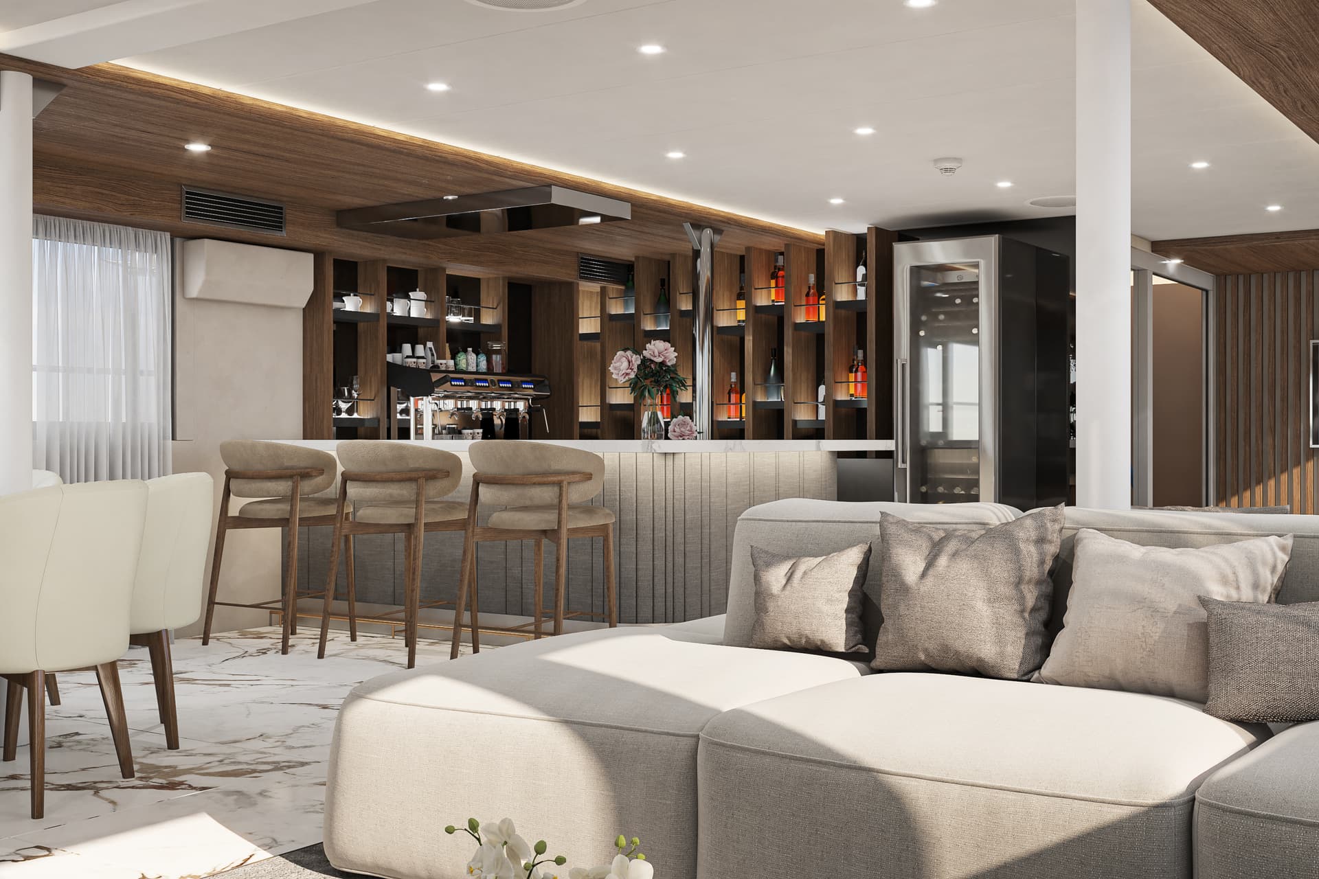 Modern lounge area with bar, espresso machine, wine cooler, and light marble floor.