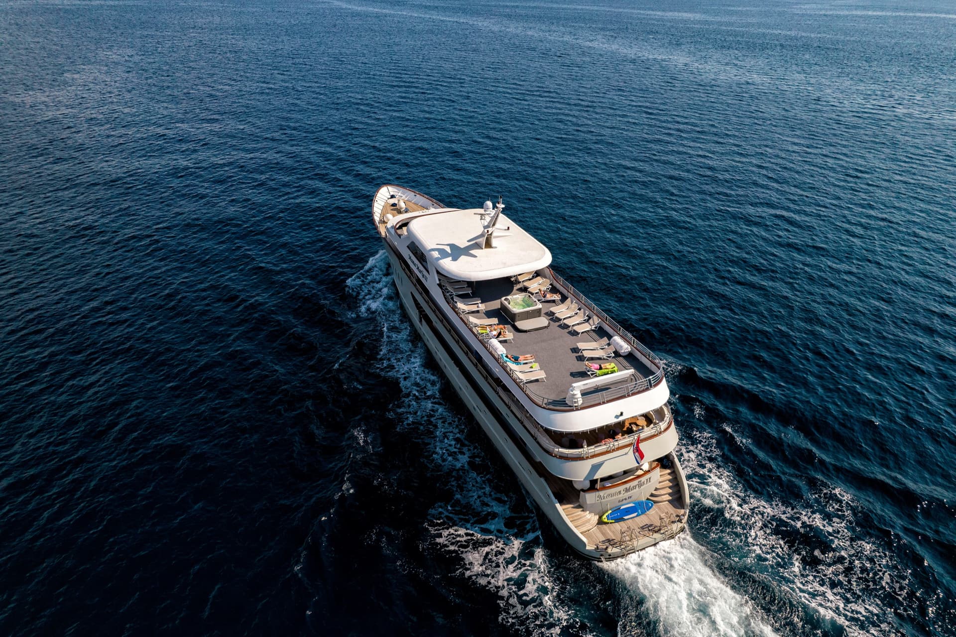 Yacht cruising on deep blue sea water