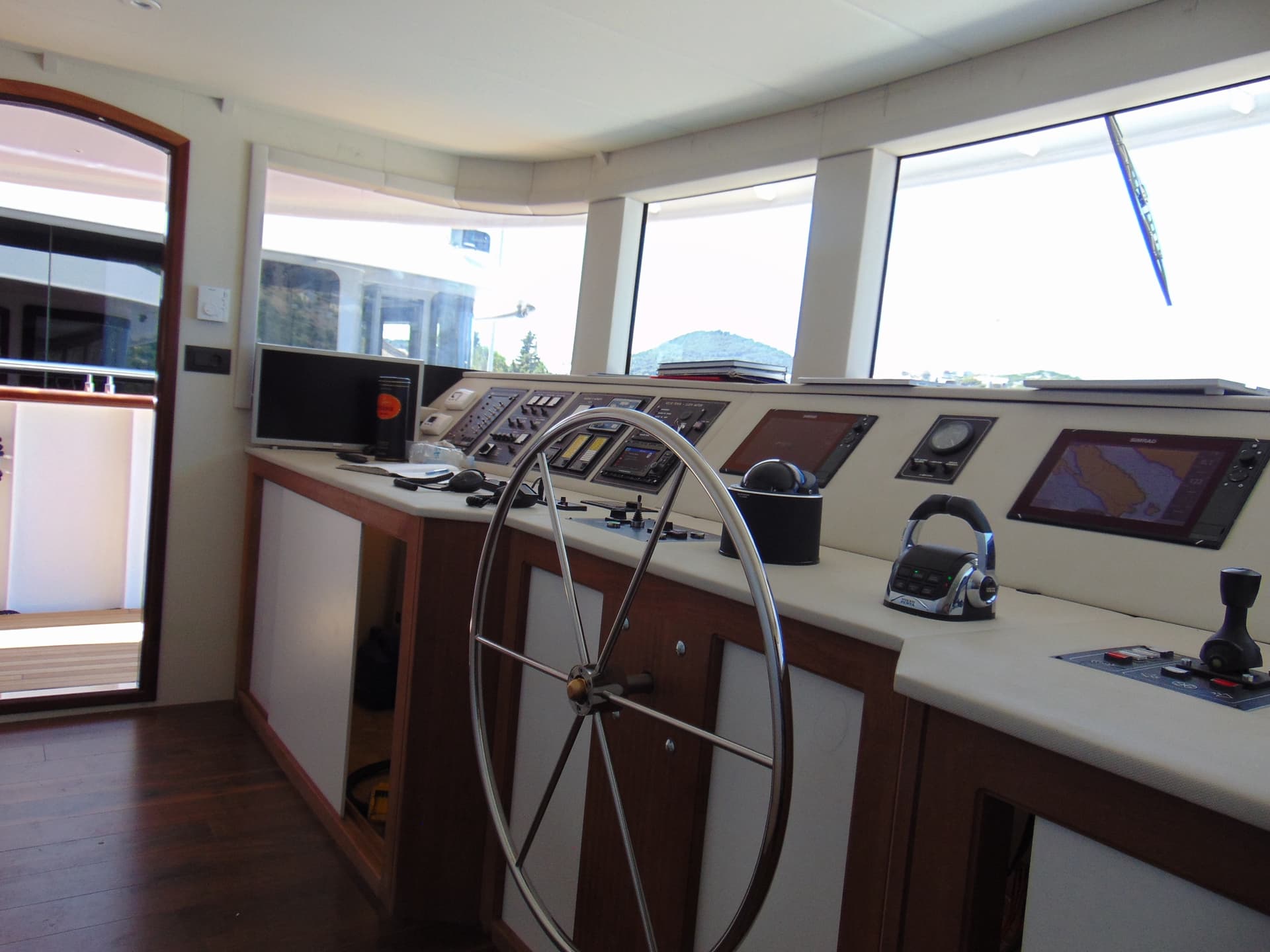 Yacht wheelhouse and control console with navigation screens