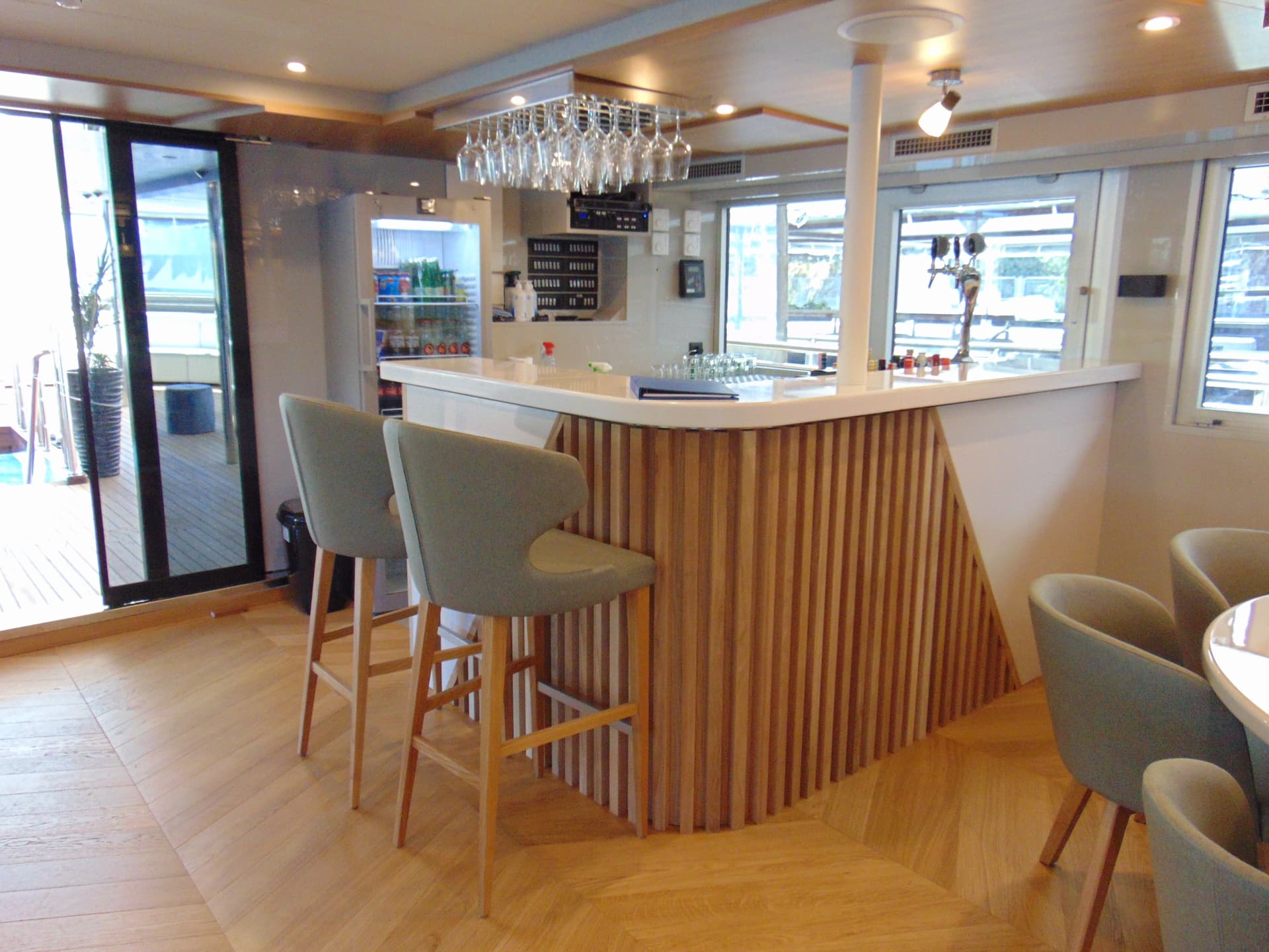 Modern indoor bar and lounge area with wooden flooring and counter seating