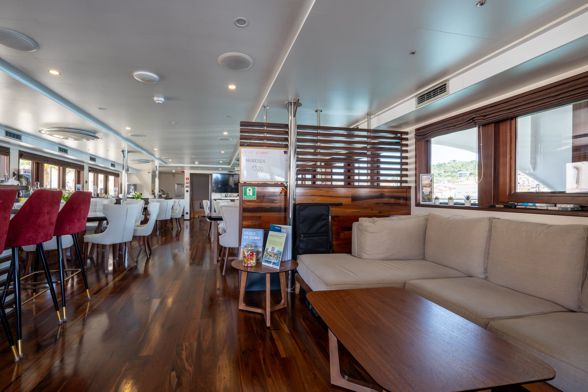Lobby bar and restaurant interior with wooden flooring and seating area