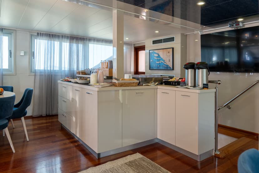 Buffet counter with food and drink dispensers on yacht interior