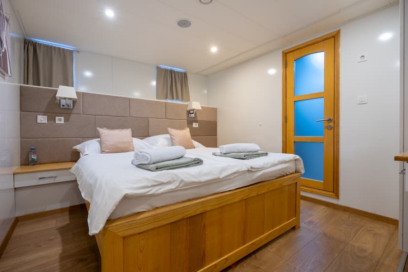 Hotel room with double bed and wooden headboard and door