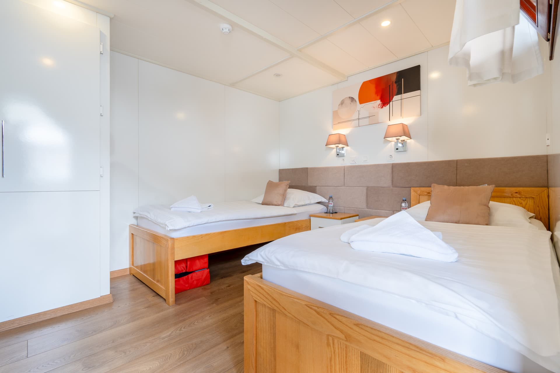 Hotel room with two twin beds and wooden frames