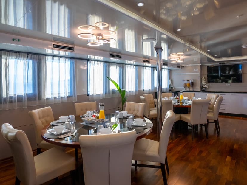 Restaurant interior on a ship with round dining tables and upholstered chairs
