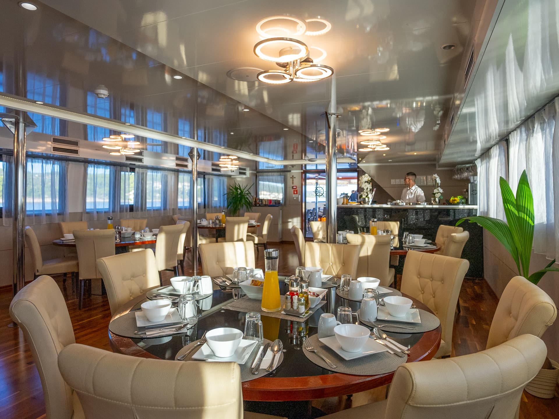 Modern restaurant interior with round dining tables and upholstered chairs