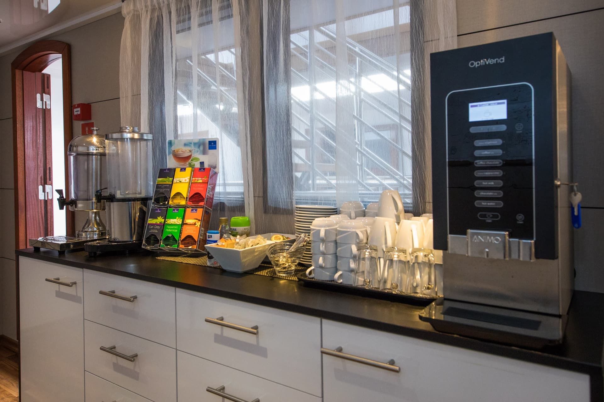 Coffee machine, tea display, and beverage station on a kitchen counter in a restaurant