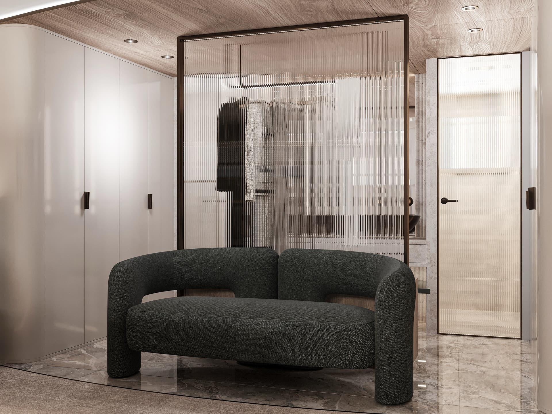 Modern dark gray sofa in a contemporary interior with fluted glass partition and white cabinets