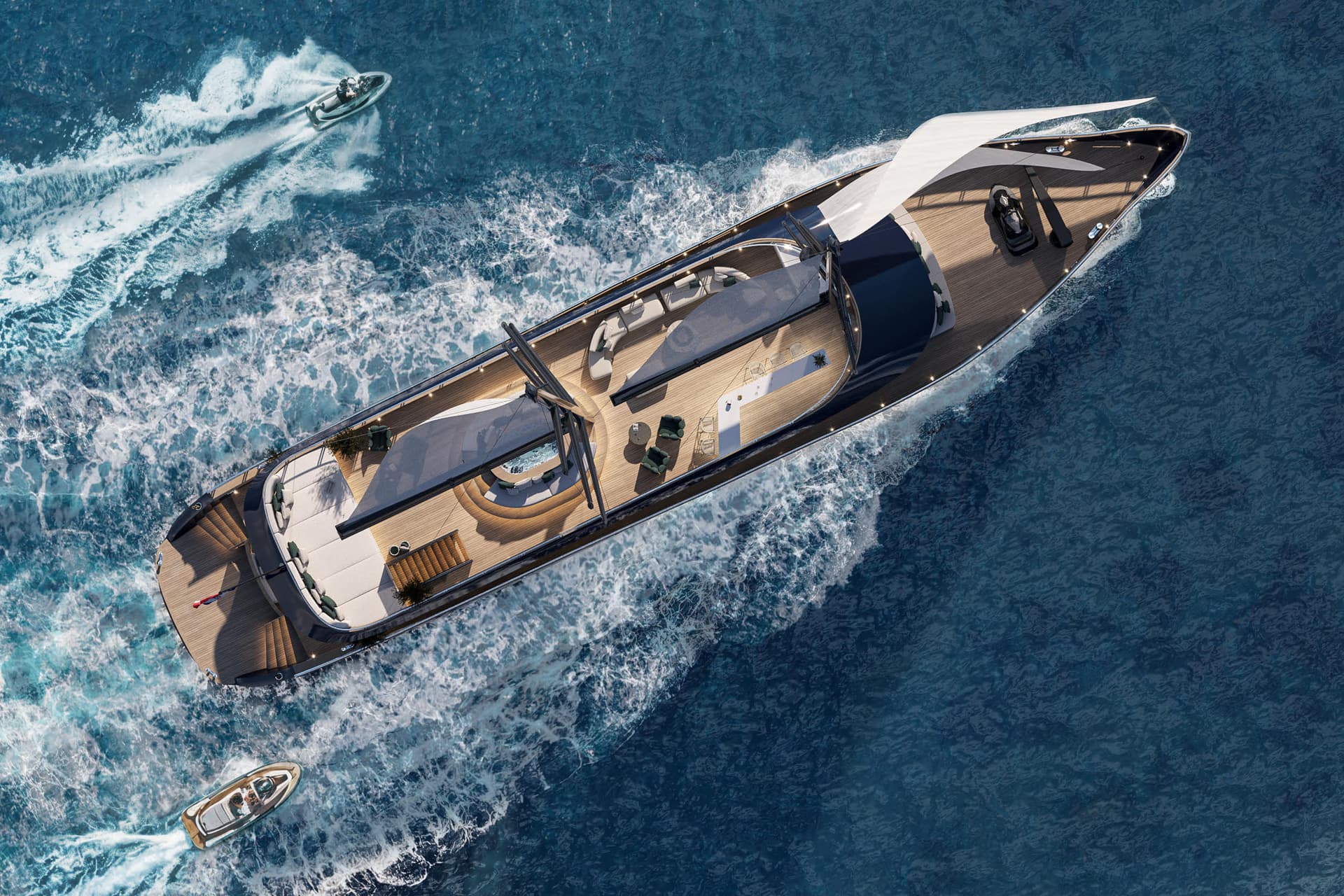Aerial view of a luxury yacht sailing on blue ocean water with smaller watercraft nearby