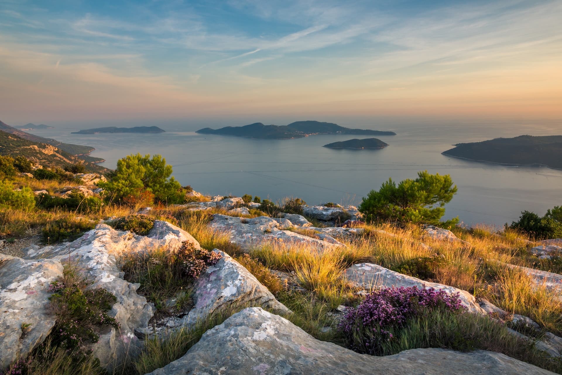 Rocky hillside overlooking islands in the sea at sunset, D2 Lopud Islands view.