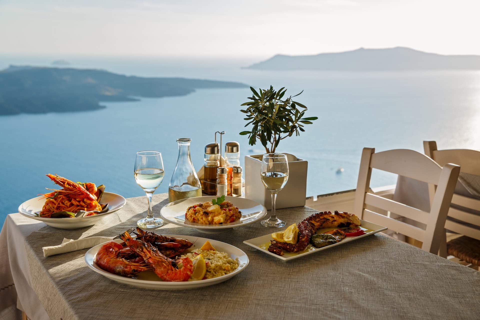 Seafood dinner with white wine overlooking the caldera and Aegean Sea in Mjlet.