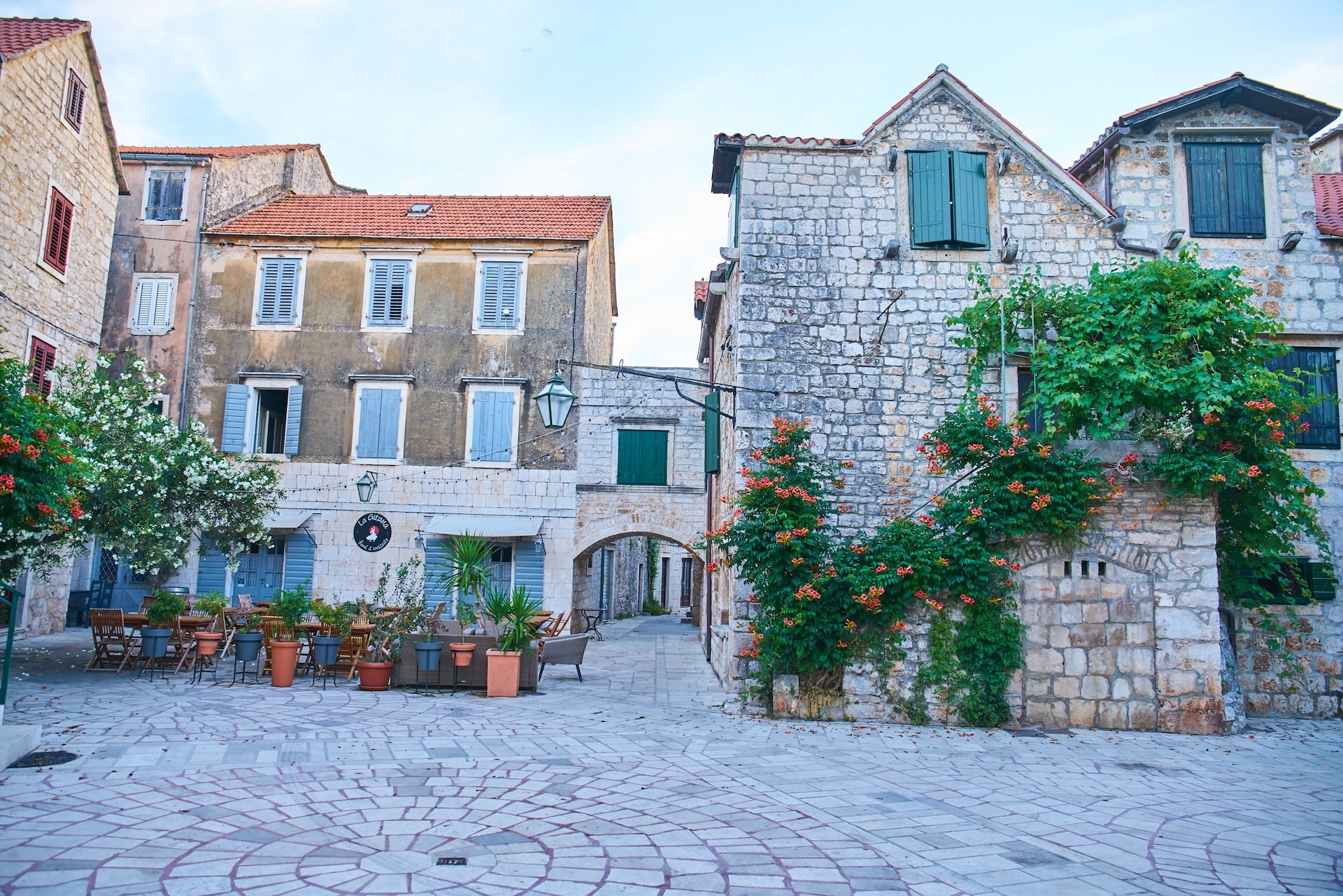 Stone buildings flank a square with outdoor cafe seating in Stari Grad, Hvar.