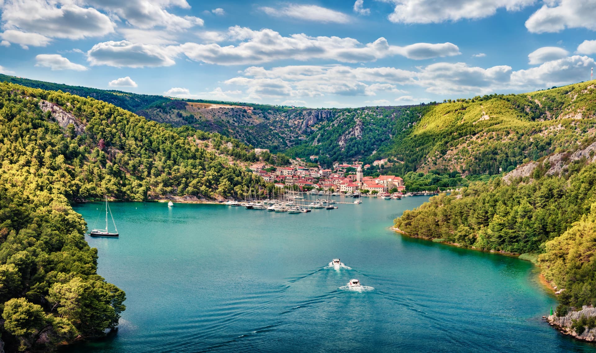 Aerial morning vire of Krka National Park, Prokljansko lake, Croatia, Europe. Picturesque summer cityscape of Skradin port. Beautiful world of Mediterranean countries. Traveling concept background.