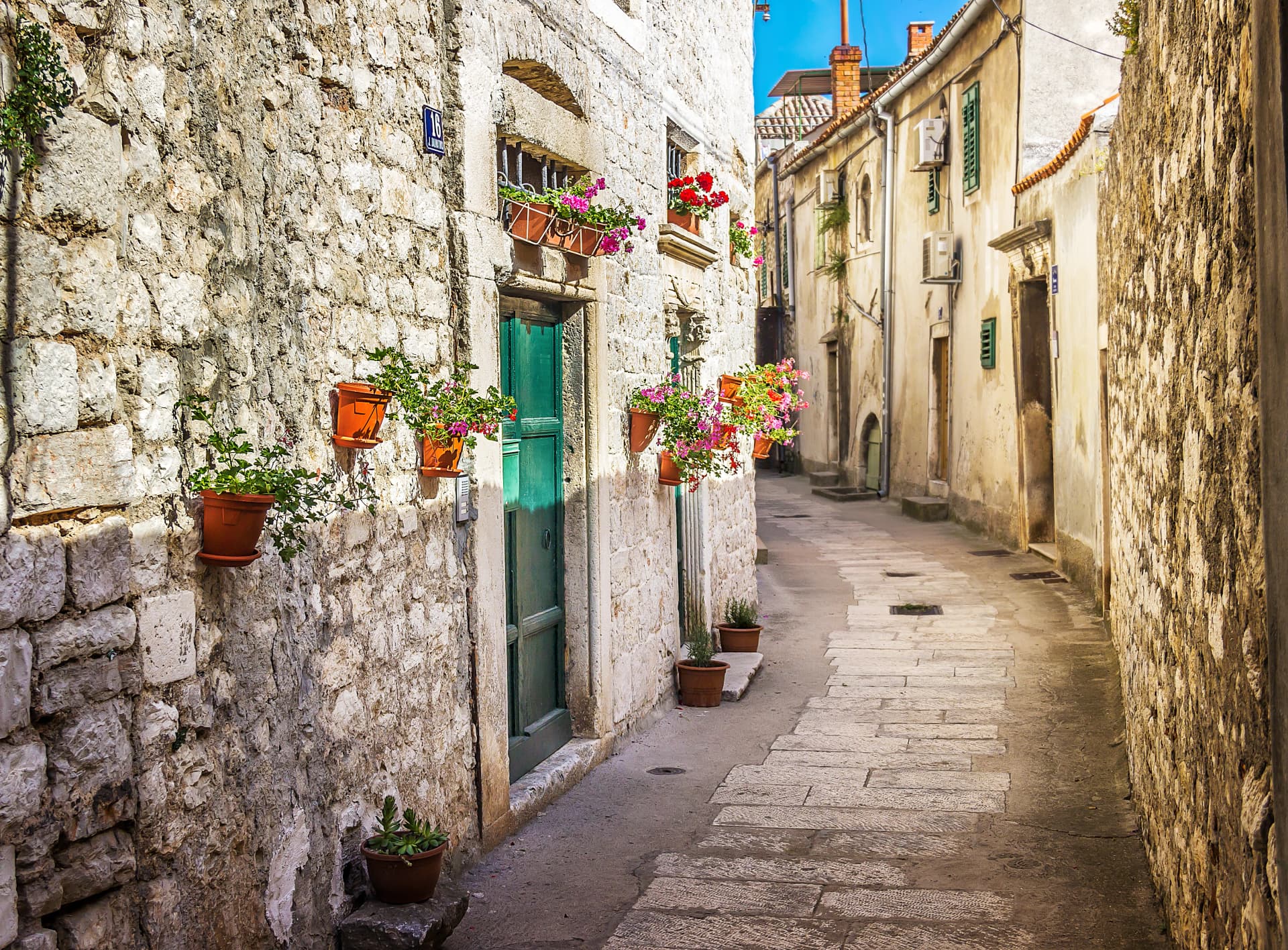 Narrow old street and yard in Sibenik city, Croatia, medieval zone