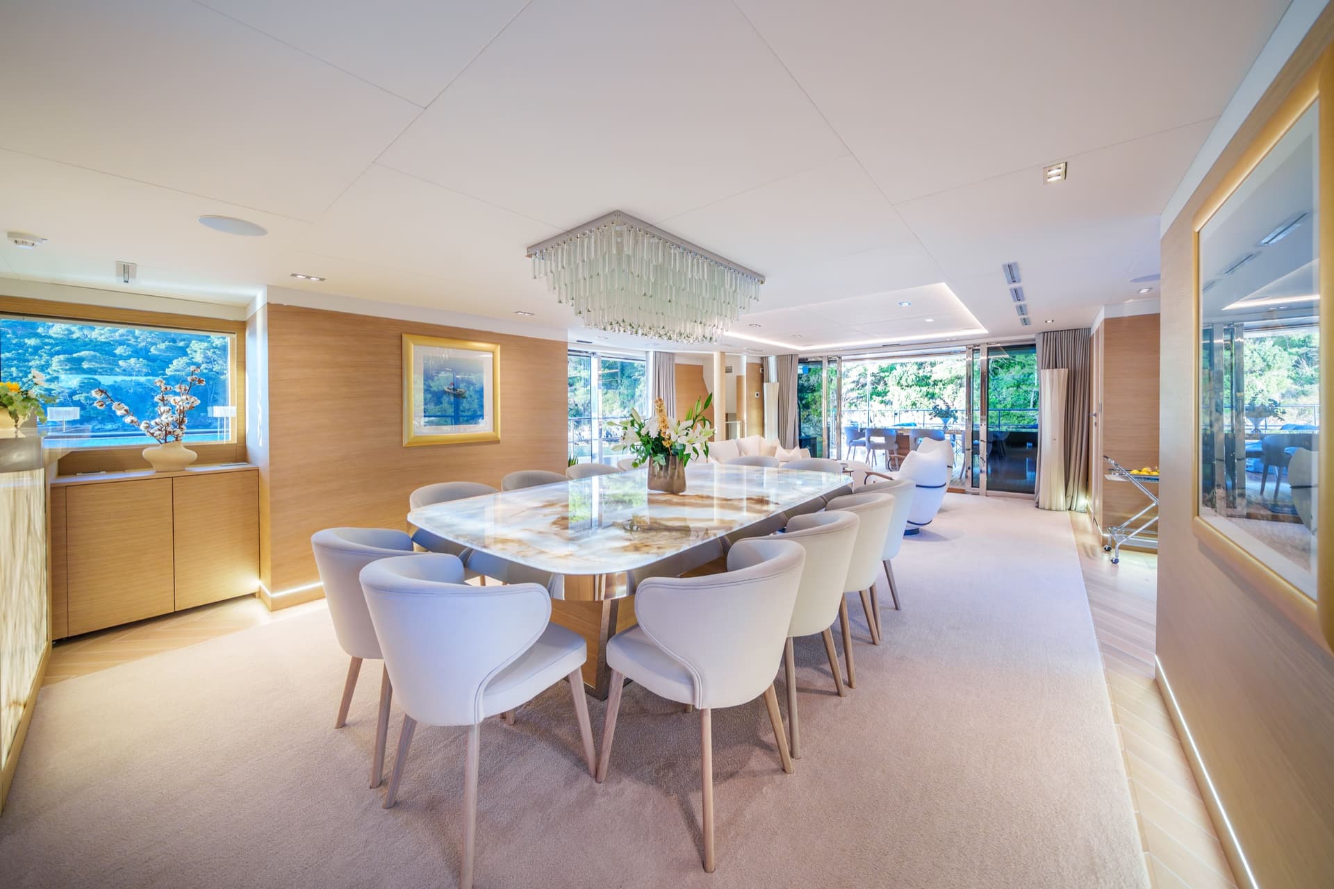 Luxury yacht dining saloon with marble table and modern white chairs
