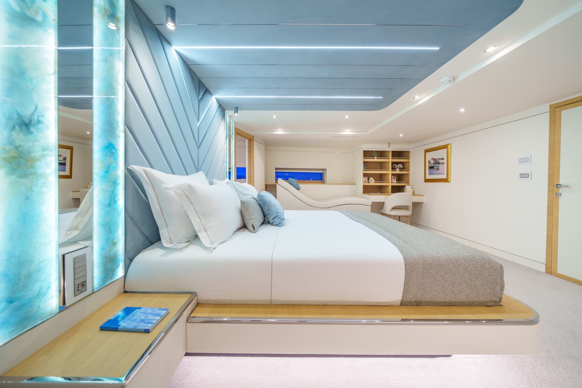 Luxury yacht VIP cabin interior with a large bed and modern blue lighting