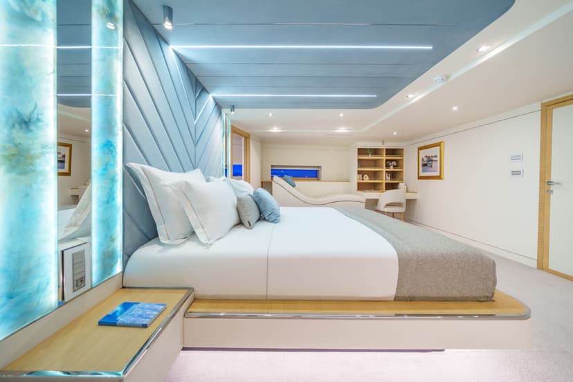Luxury yacht VIP cabin interior with a large bed and modern blue lighting