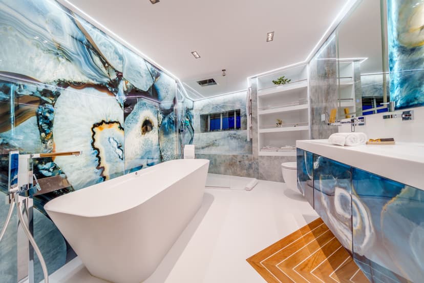 Luxury yacht VIP cabin bathroom with freestanding bathtub and blue gemstone tile wall